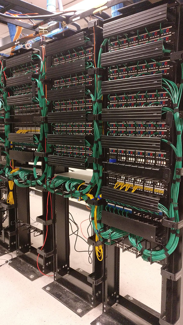 A large rack of wires and cables in a room.