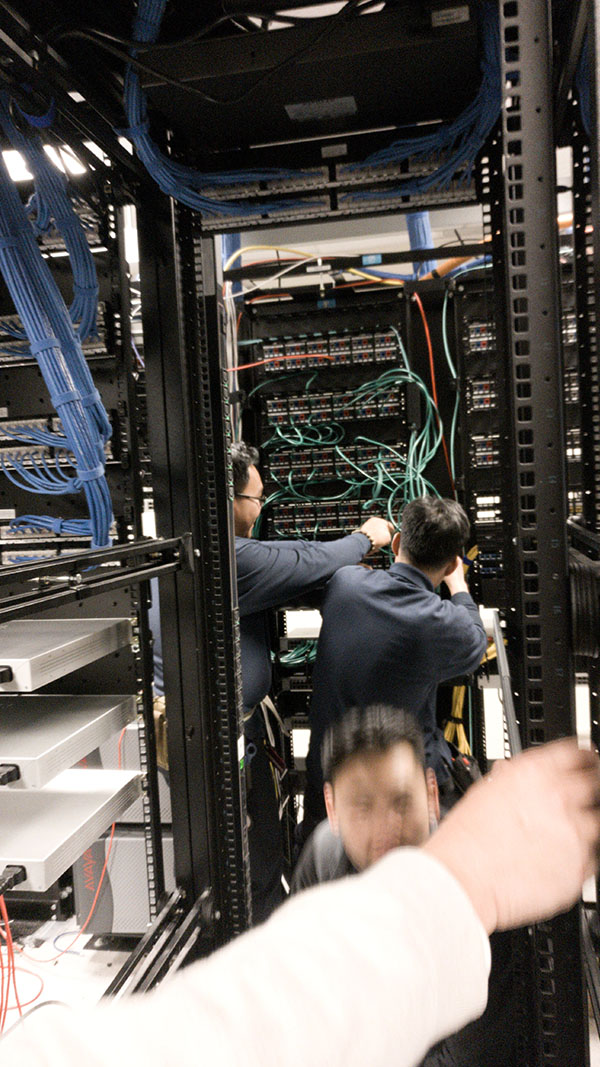A man working on some wires in an office.