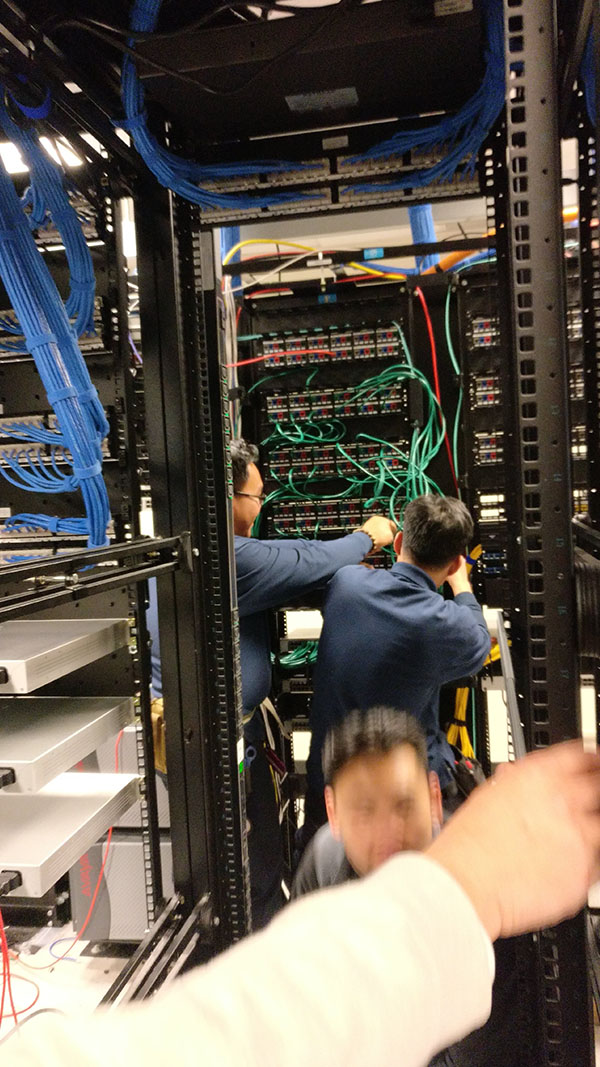 A man working on some wires in an office.