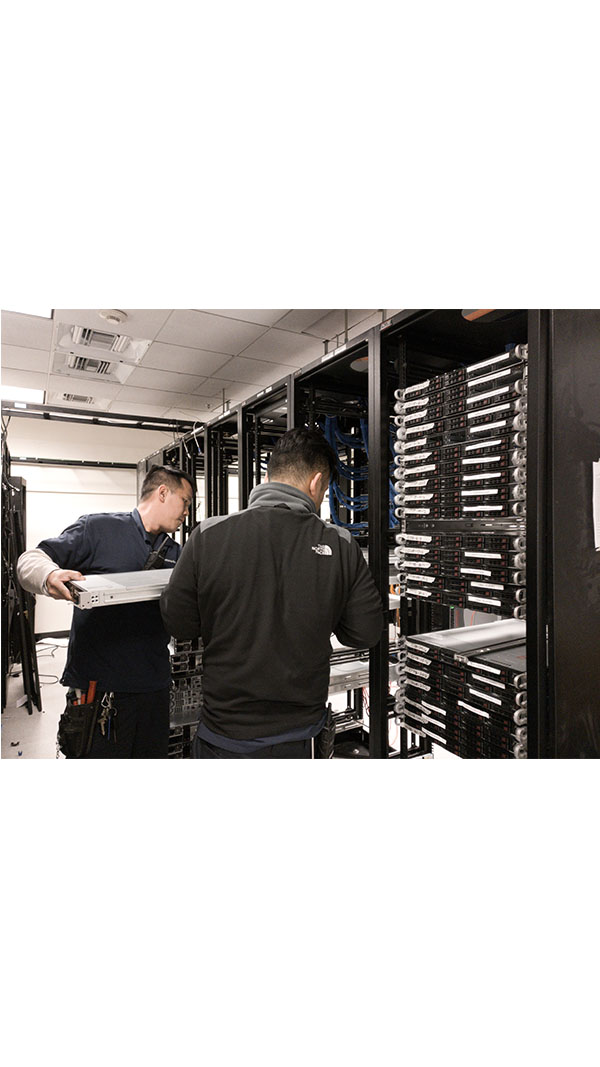 Two men working in a server room