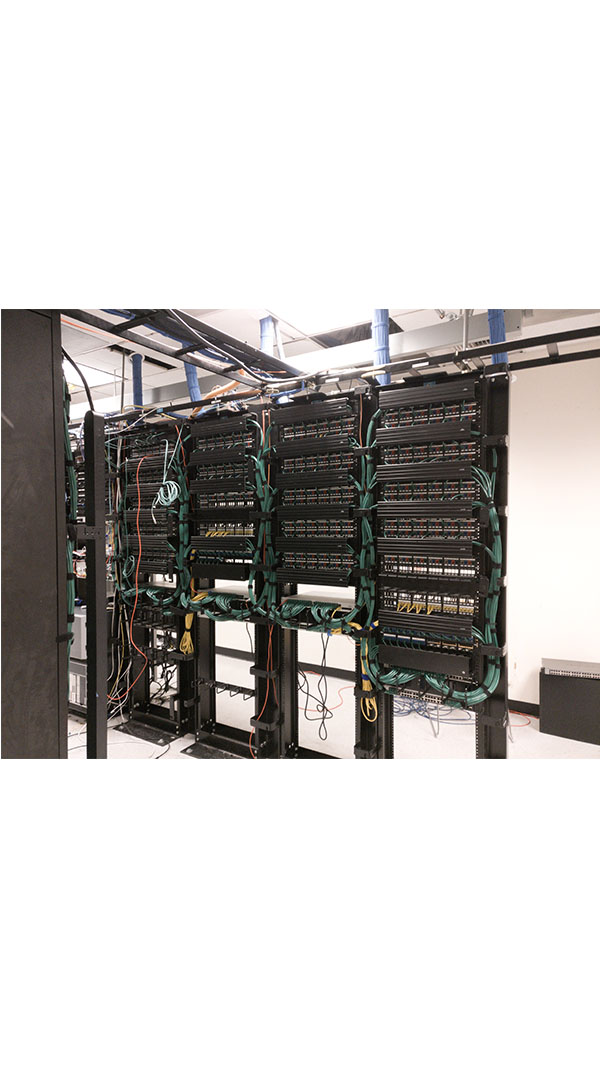 A room with many wires and racks in it