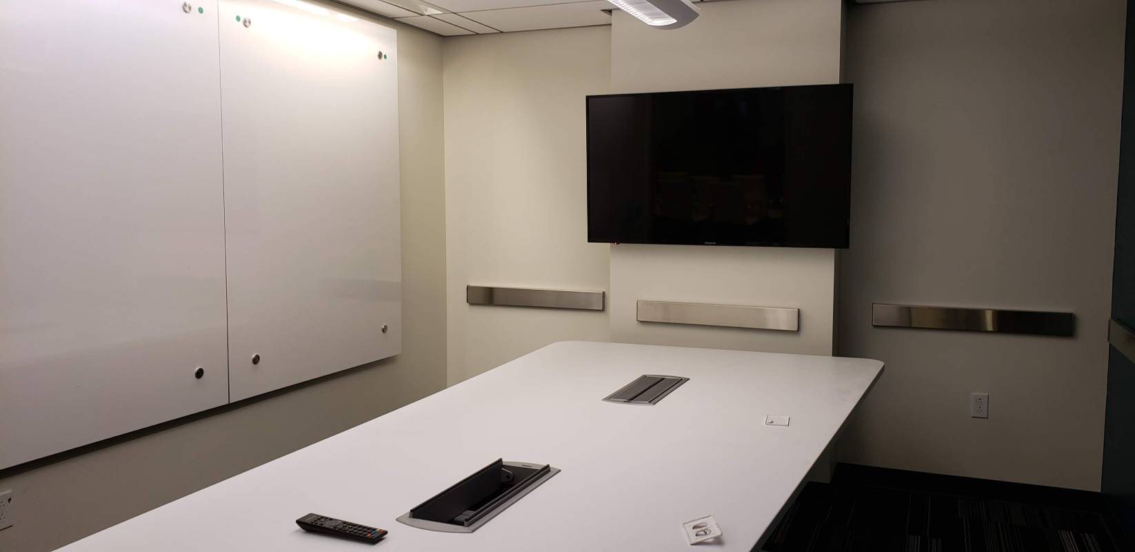 A white table with two cell phones on it.