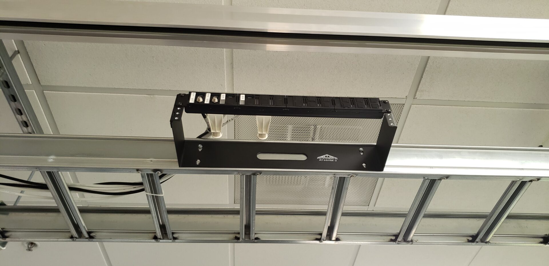 A garage door opener is mounted to the ceiling.