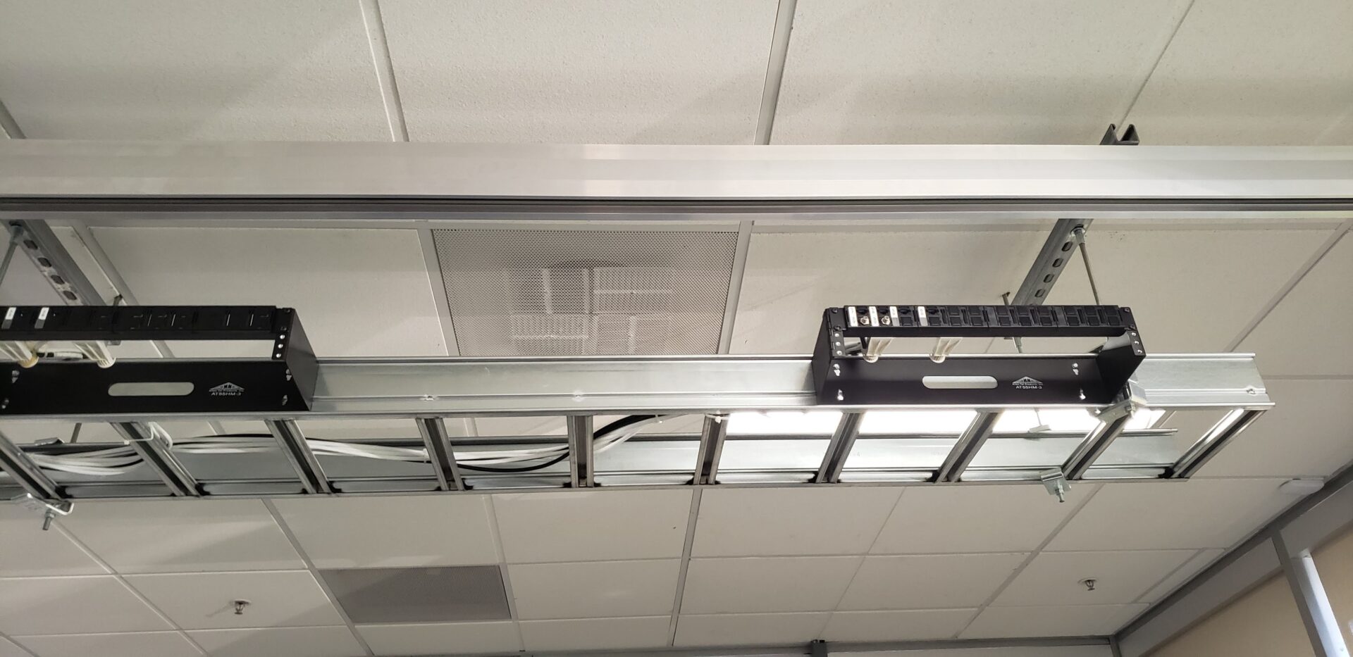 A ladder hanging from the ceiling of an office building.