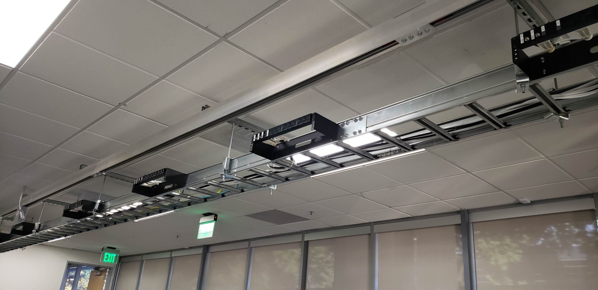 A ceiling with lights and wires hanging from the ceiling.