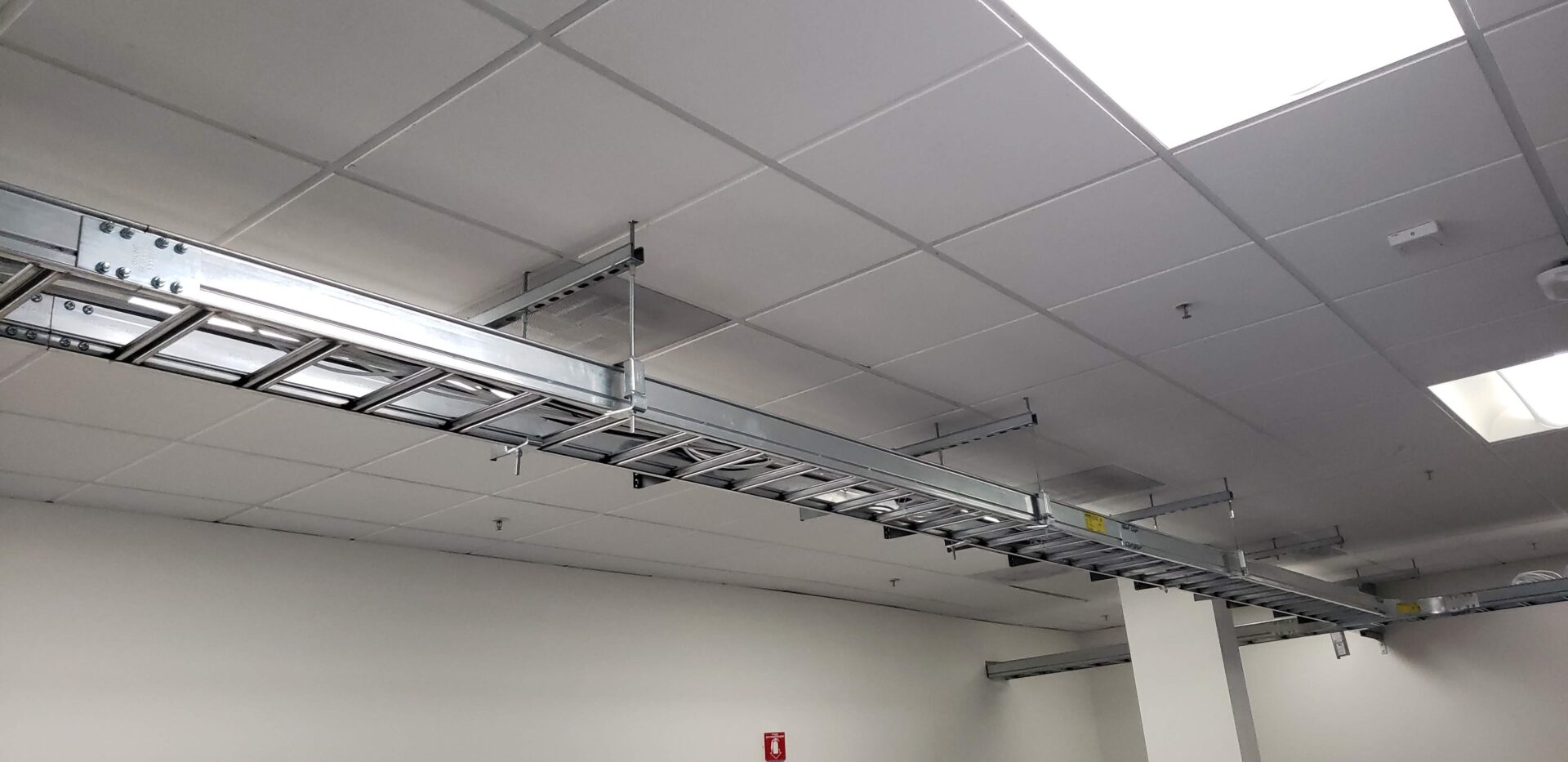 A ceiling with many wires hanging from it