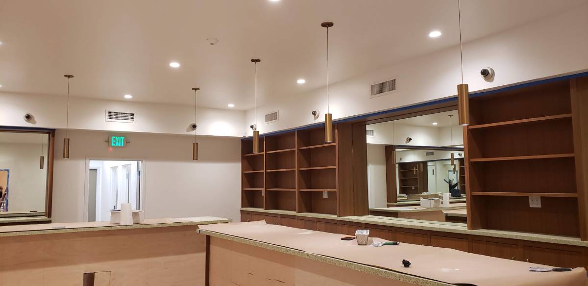 A room with a large mirror and shelves.