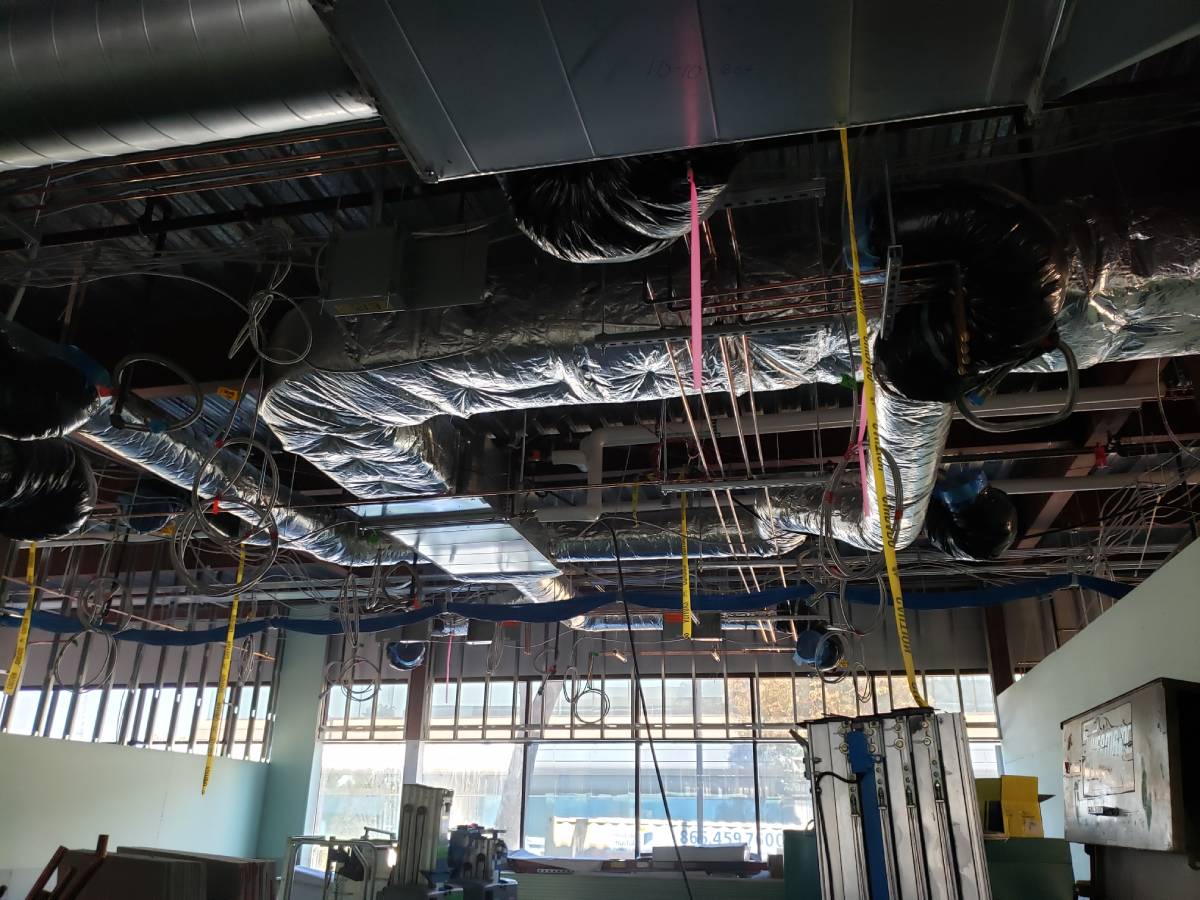 A room with many wires hanging from the ceiling.