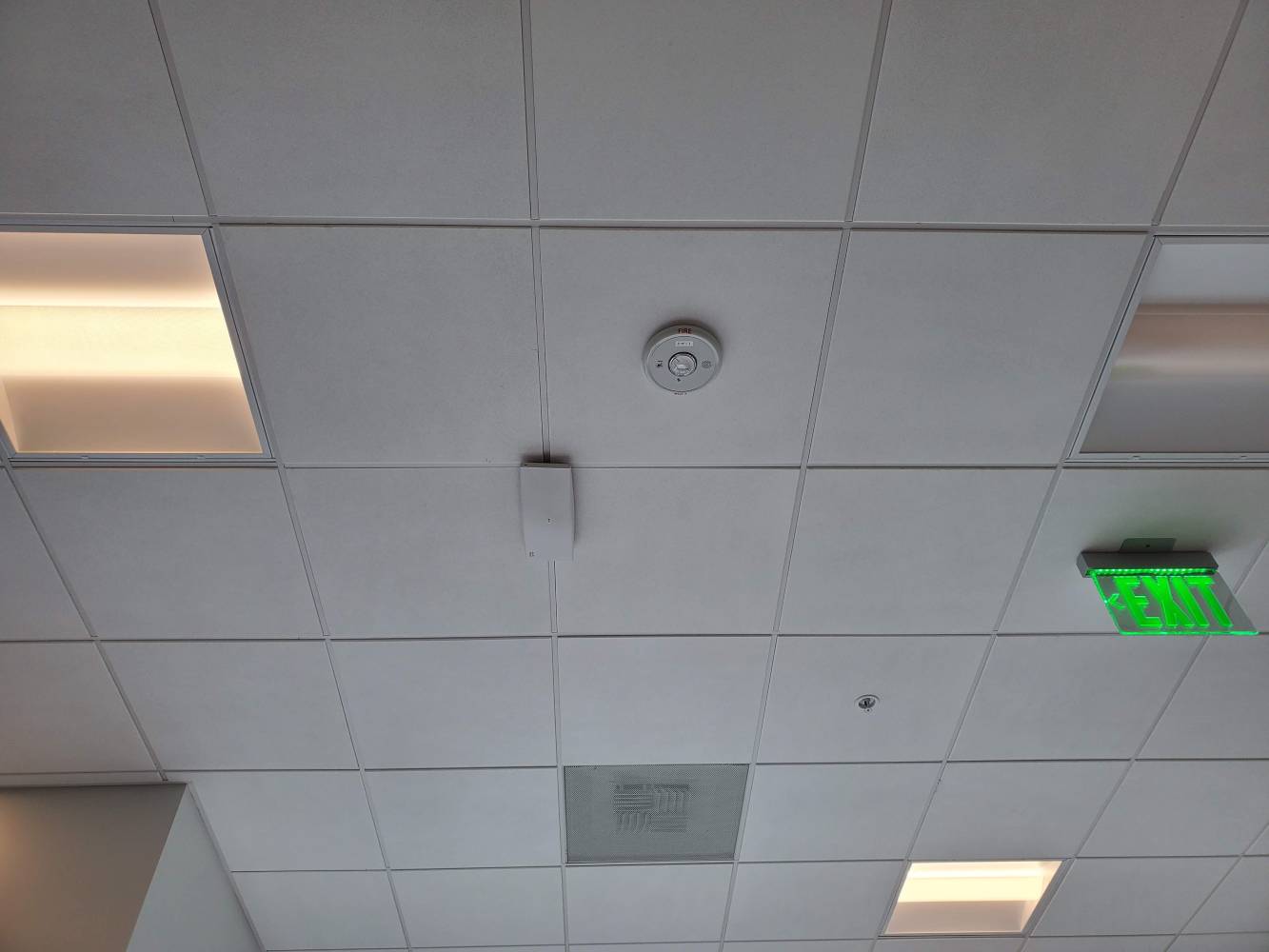 A ceiling with many lights and wires hanging from it.