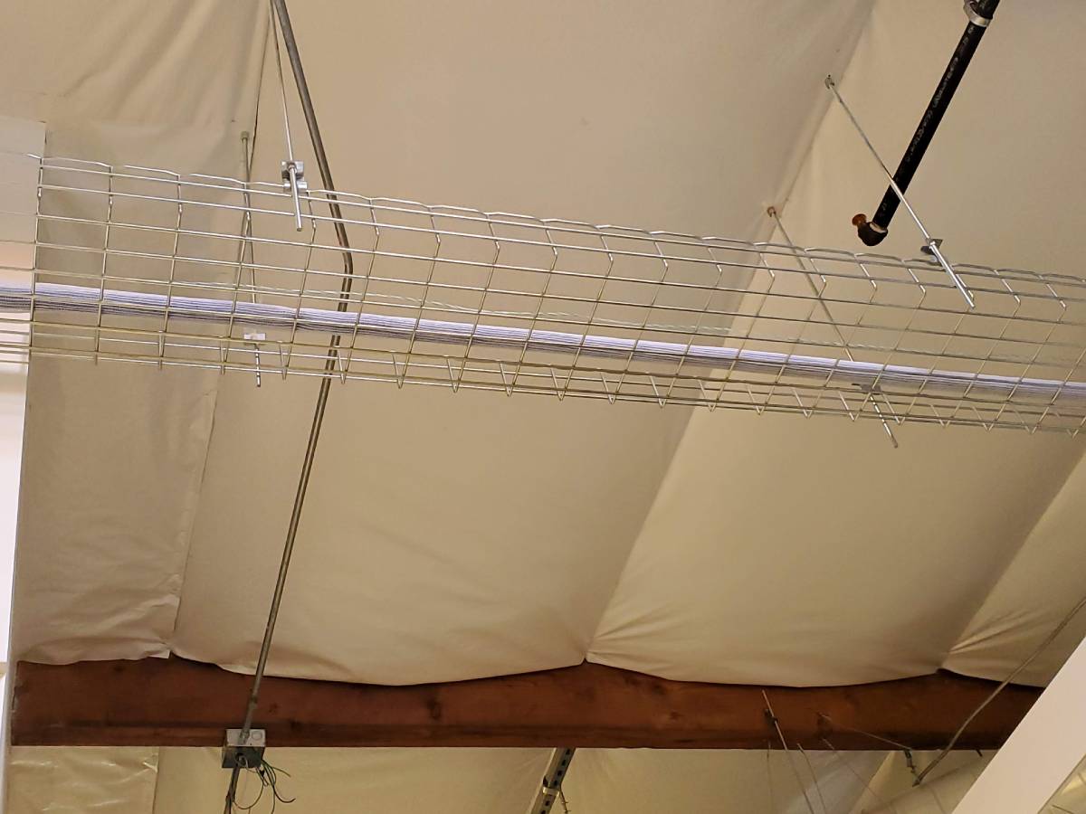 A ceiling with a wire rack hanging from it.