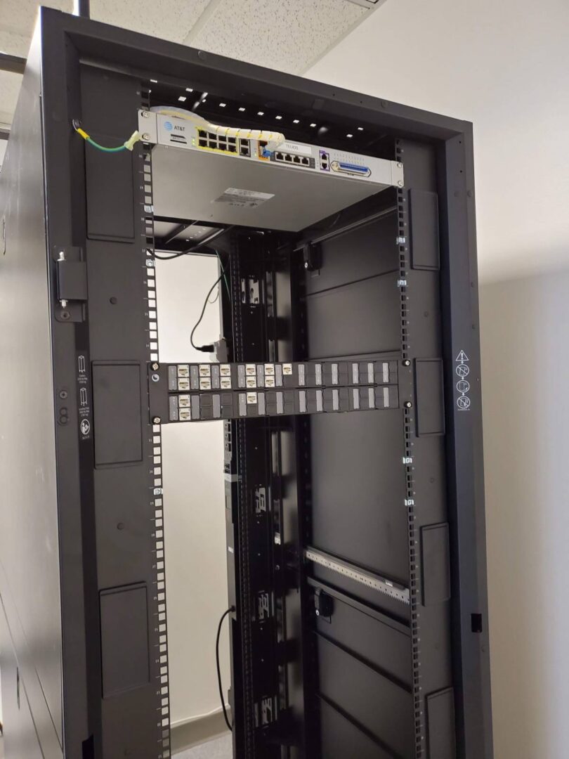 A rack with many wires and boxes in it