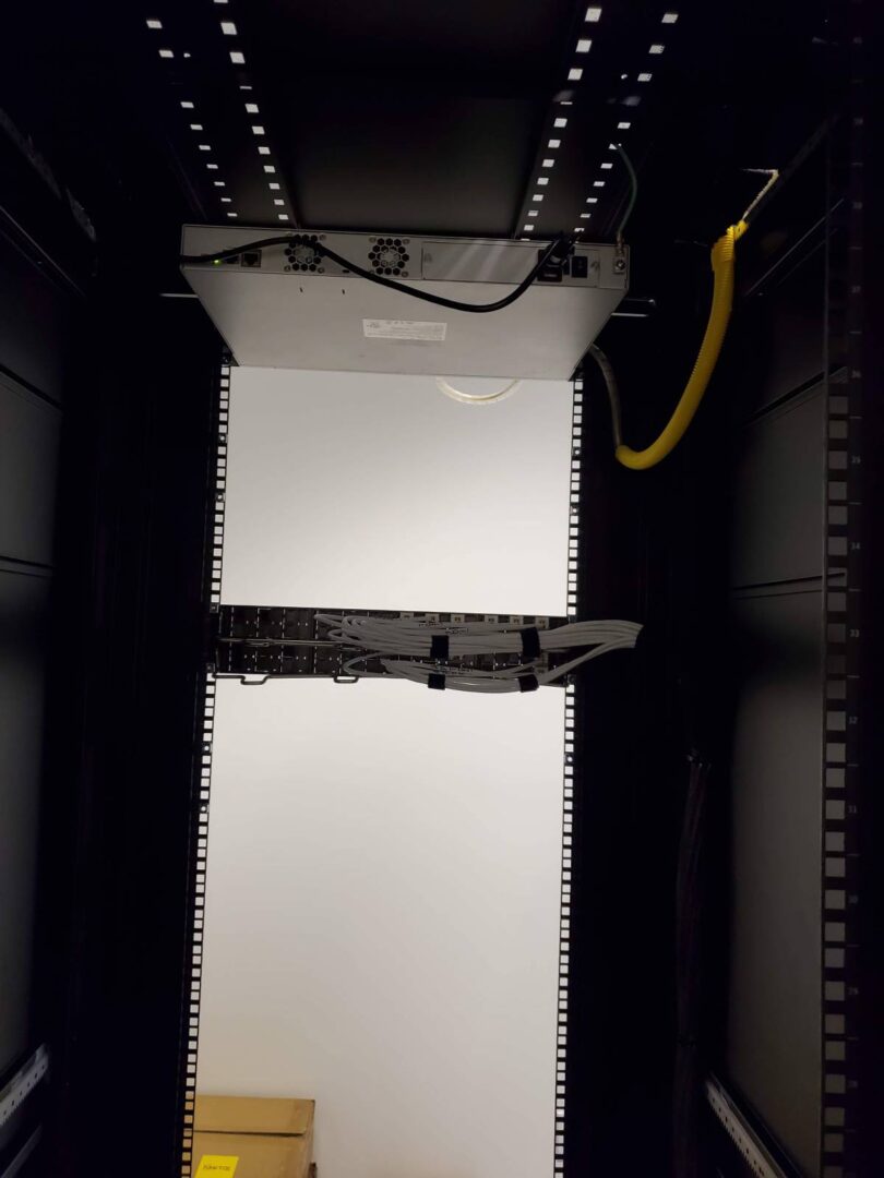 A white light is on in the middle of an elevator.
