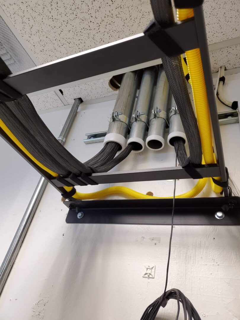 A bunch of pipes hanging from the ceiling